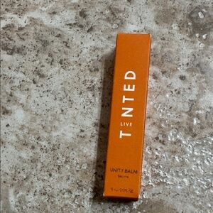 Live Tinted Unity Balm in carnal glaze. New in box